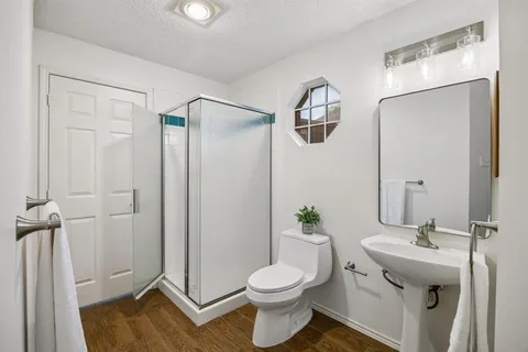 a bathroom with a sink toilet and shower