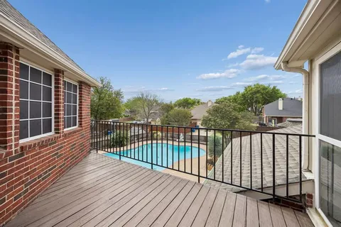 a view of balcony with wooden floor and fence