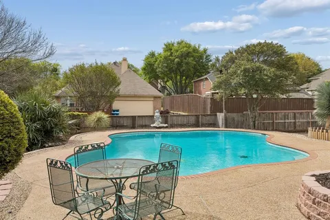 a swimming pool with outdoor seating and yard