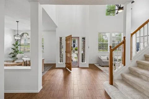 a view of an entryway with wooden floor and windows