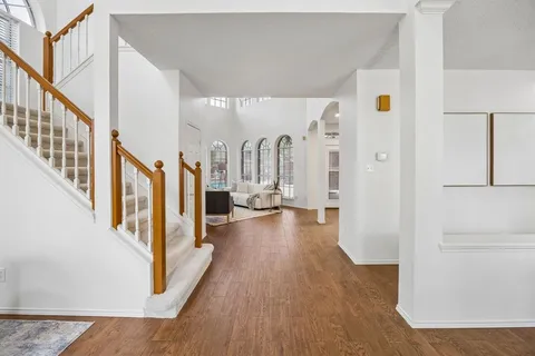 a view of a hallway view with wooden floor and staircase