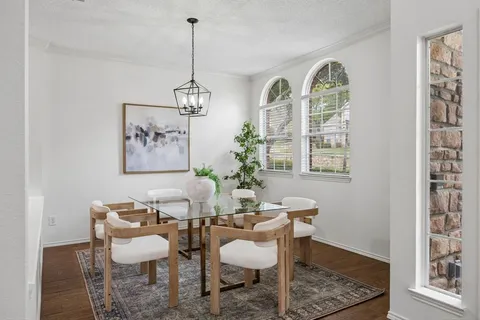 a dining room with furniture a rug and a window