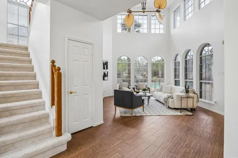 a living room with furniture and wooden floor