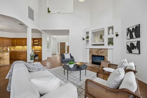 a living room with furniture fireplace and window