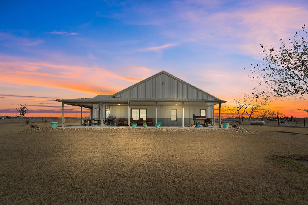 151 County Road 373 Mathis, TX 78368 - Photo 1 of 1 a front view of house with yard and trees in the background