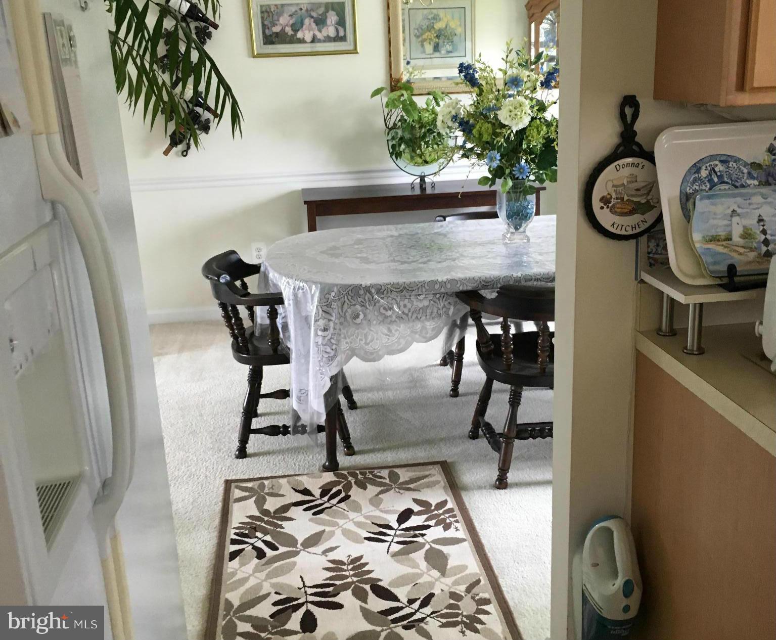 9316 Sea Point Road Baltimore, MD 21219 - Photo 11 of 30 a dining room with furniture and a potted plant