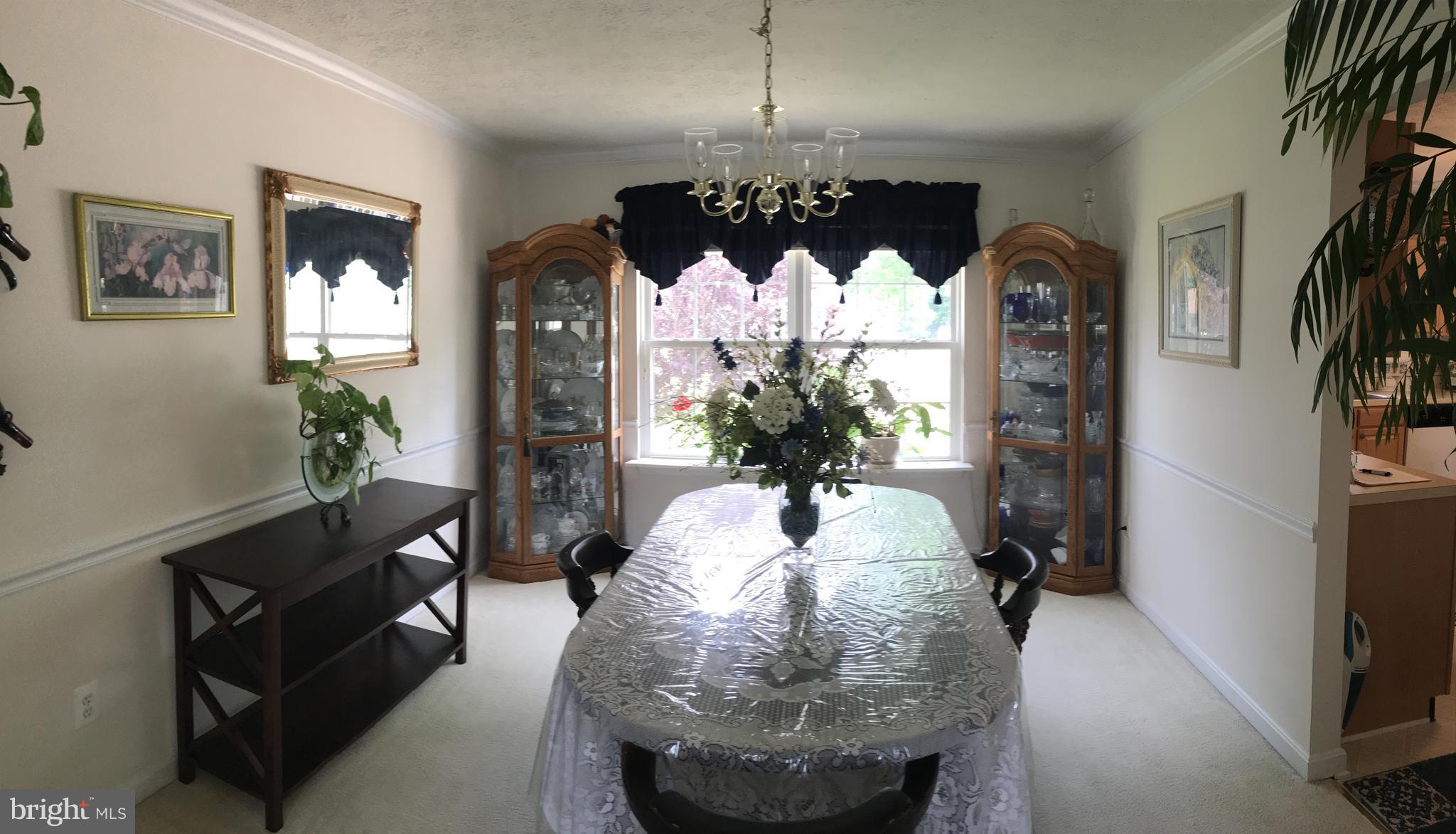 9316 Sea Point Road Baltimore, MD 21219 - Photo 12 of 30 a view of a dining room with furniture and a chandelier