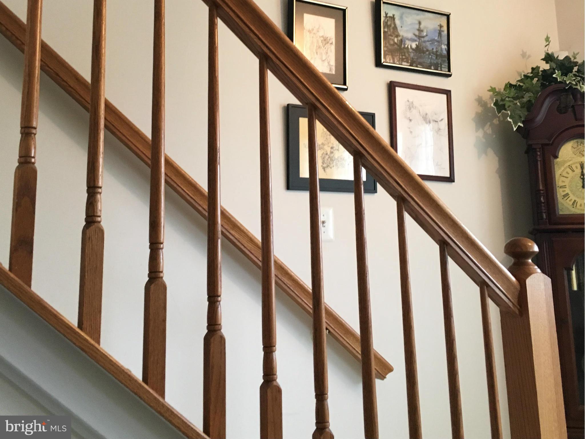 9316 Sea Point Road Baltimore, MD 21219 - Photo 13 of 30 a view of staircase with lots of frames on wall and a window