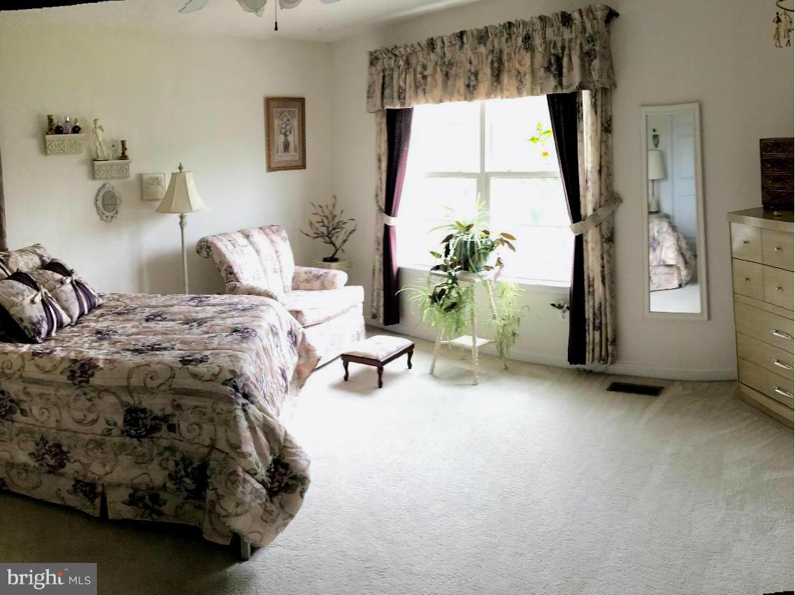 9316 Sea Point Road Baltimore, MD 21219 - Photo 15 of 30 a bed sitting in a bedroom next to a window