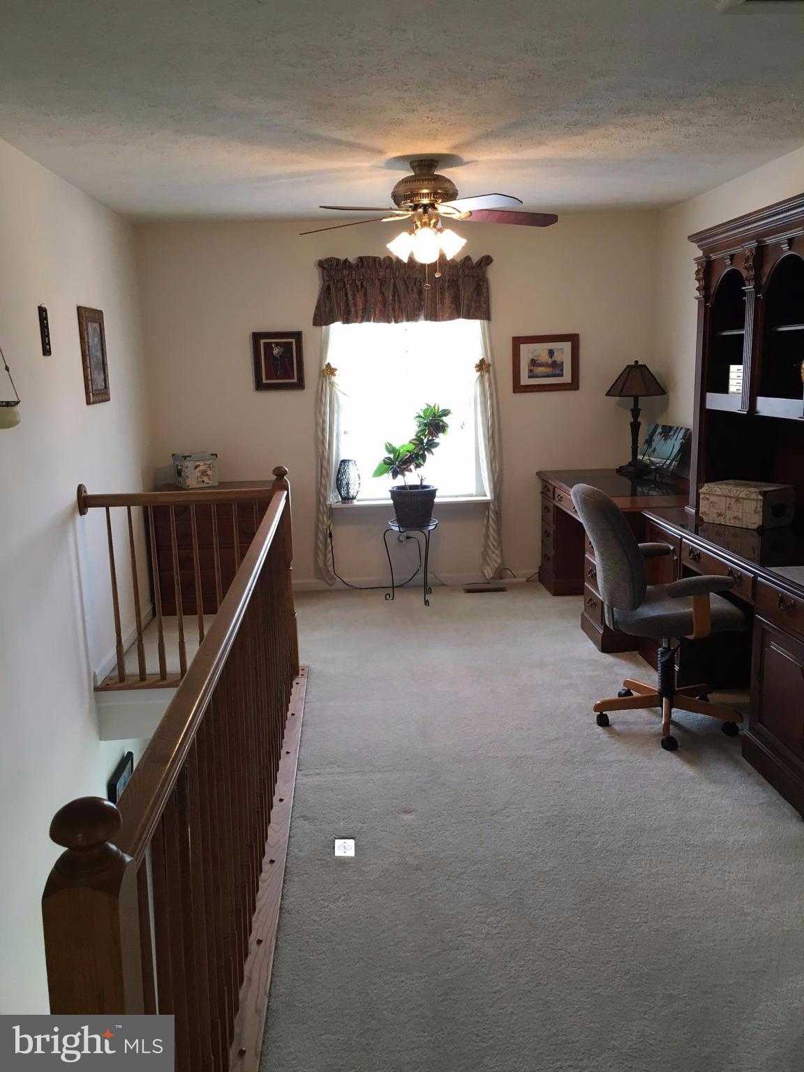 9316 Sea Point Road Baltimore, MD 21219 - Photo 23 of 30 a living room with furniture and a chandelier