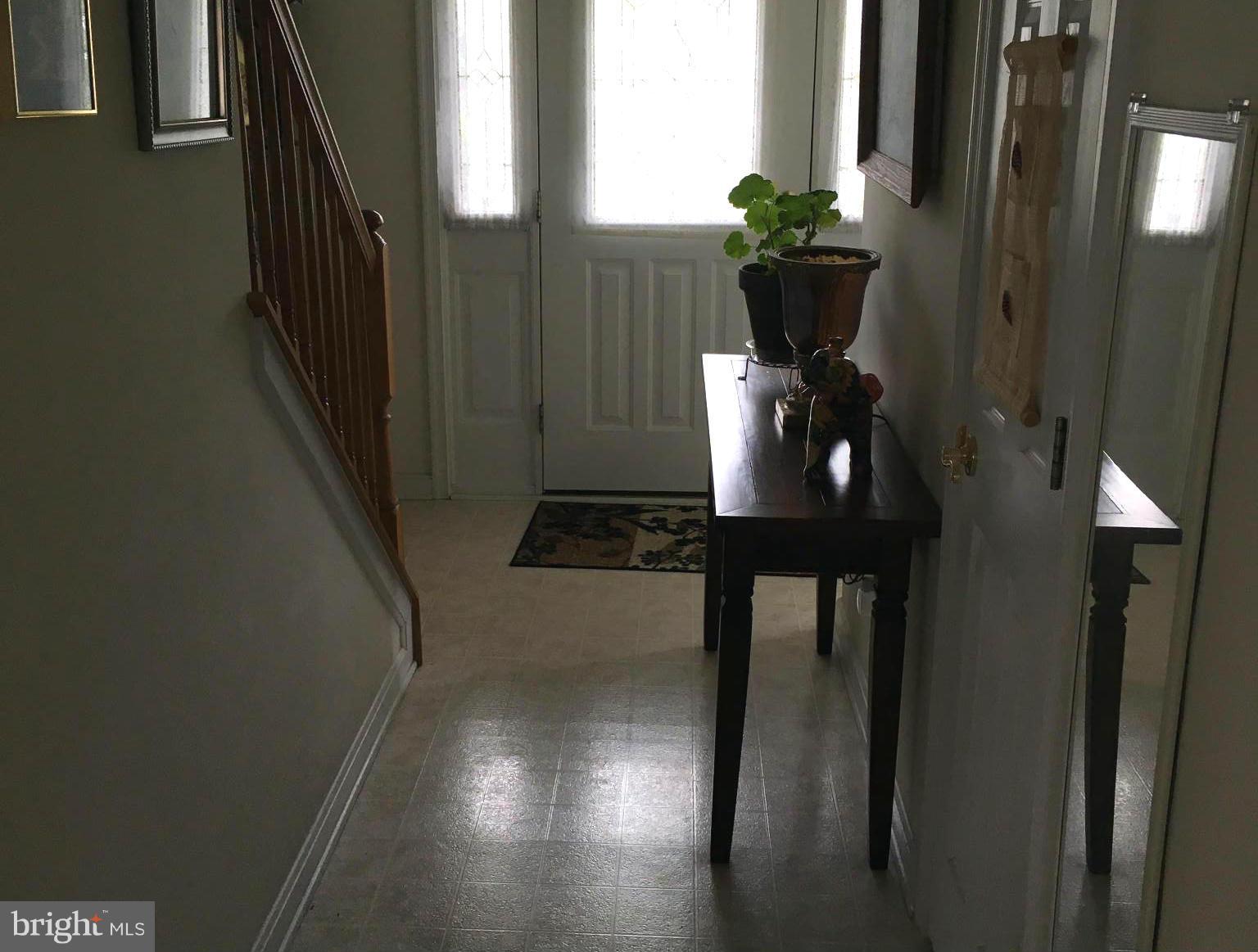 9316 Sea Point Road Baltimore, MD 21219 - Photo 26 of 30 a view of a hallway with wooden floor and a dining room