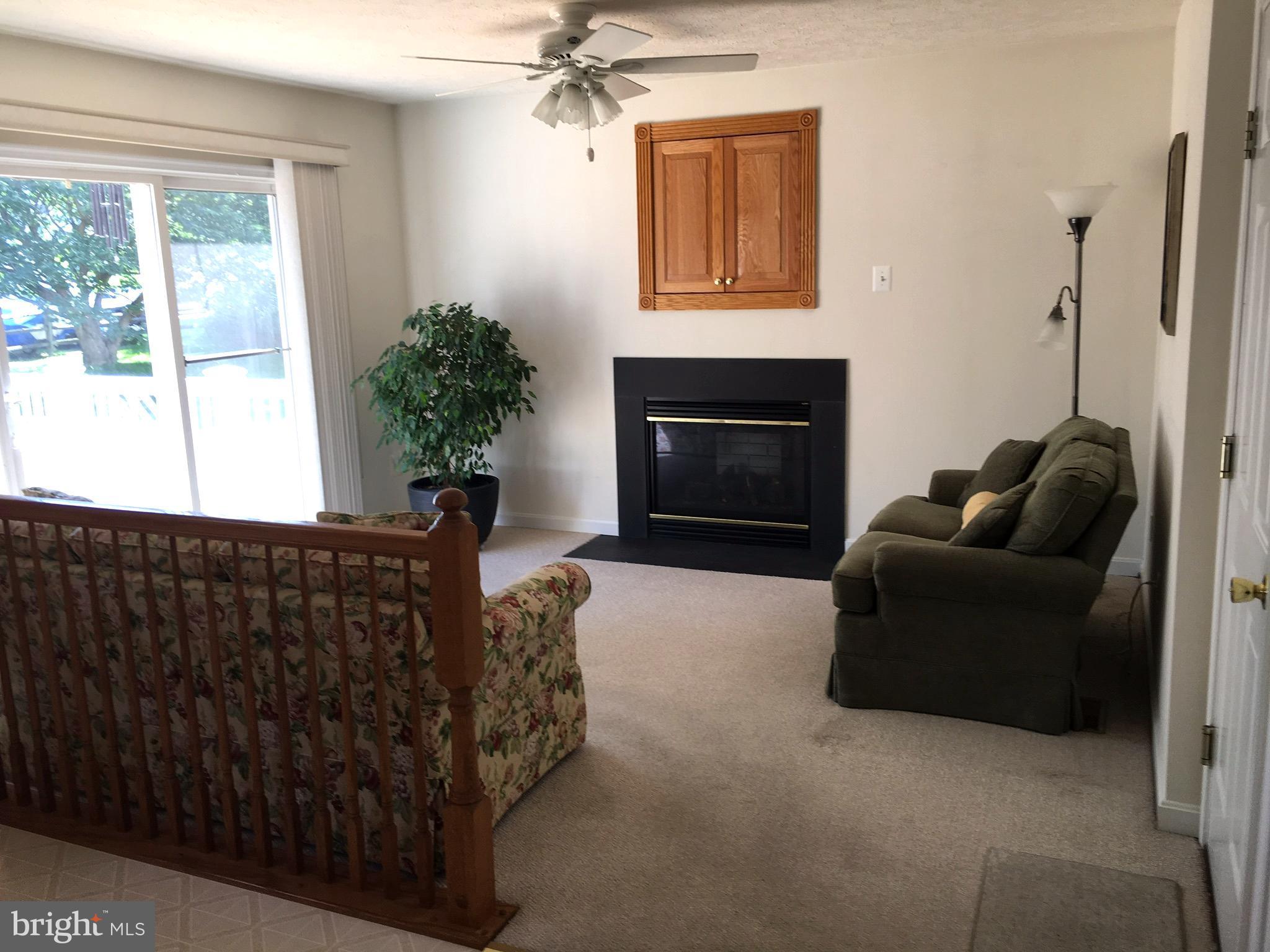 9316 Sea Point Road Baltimore, MD 21219 - Photo 8 of 30 a living room with furniture a window and a fireplace