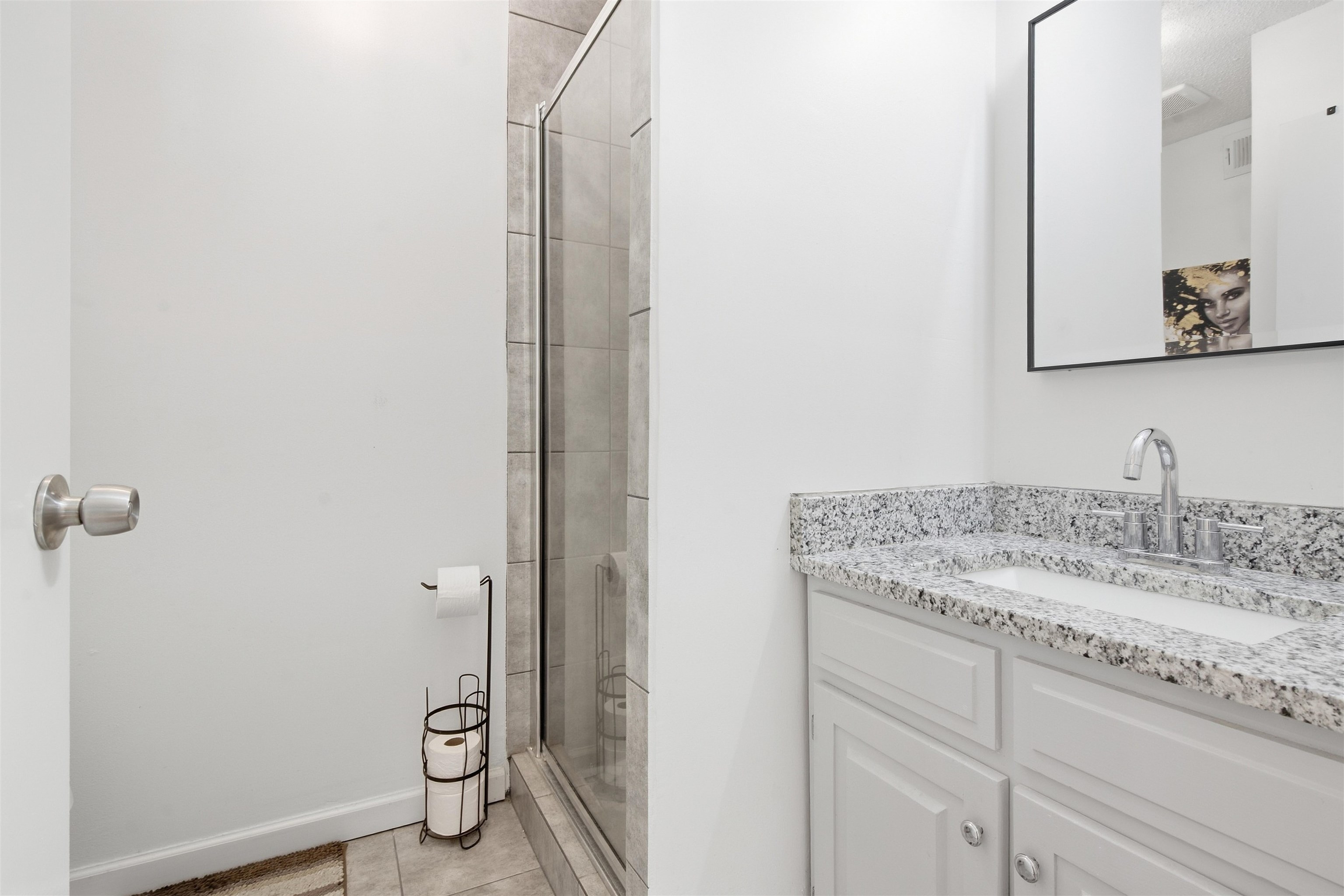 8367 Brownstone Lane, Unit 22 Cordova, TN 38016 - Photo 13 of 20 Shower with glass enclosure, tile surround, vanity with light-toned countertop, integrated sink, and undermount cabinetry