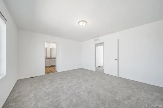 a front view of a house with a garden and plants
