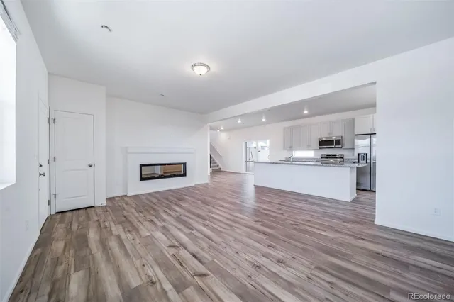 a view of kitchen and kitchen with wooden floor