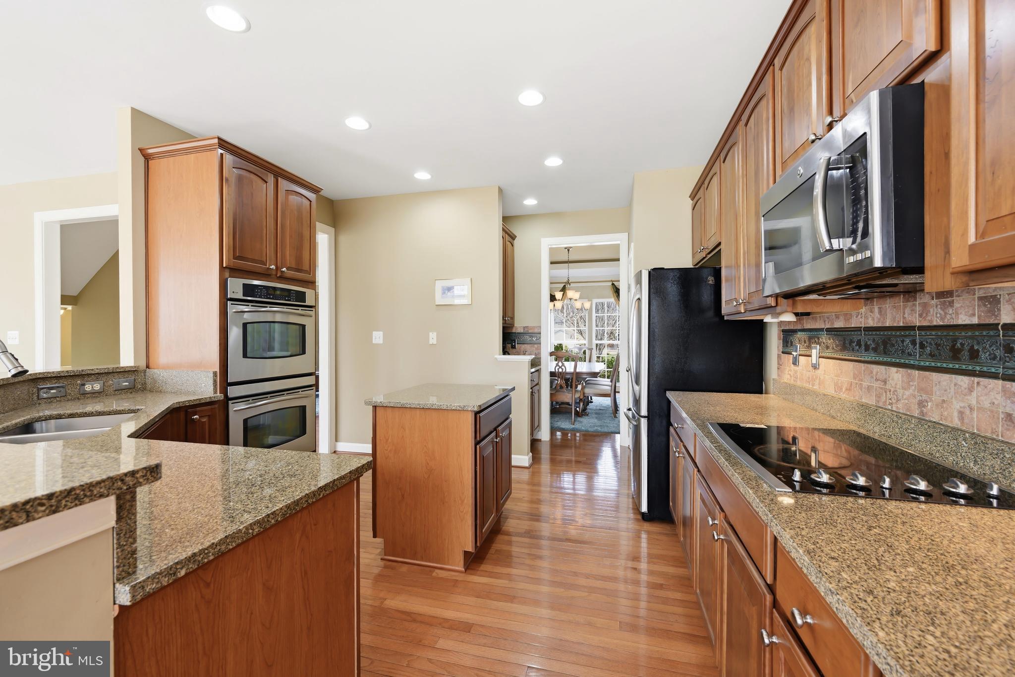 103 Sutton Way Chestertown, MD 21620 - Photo 24 of 53 a kitchen with stainless steel appliances granite countertop a stove a sink and a microwave