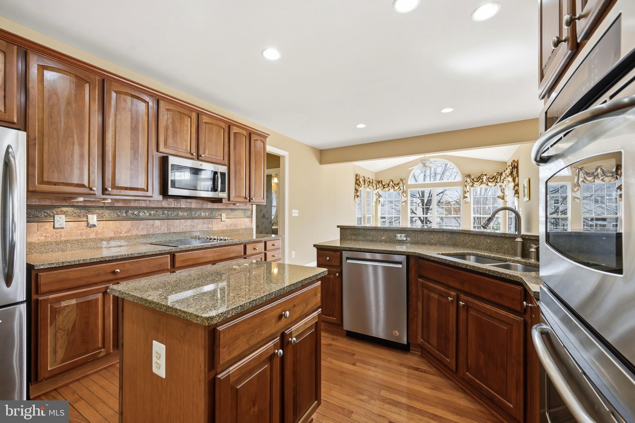 103 Sutton Way Chestertown, MD 21620 - Photo 26 of 53 a kitchen with stainless steel appliances granite countertop a stove a sink and a microwave