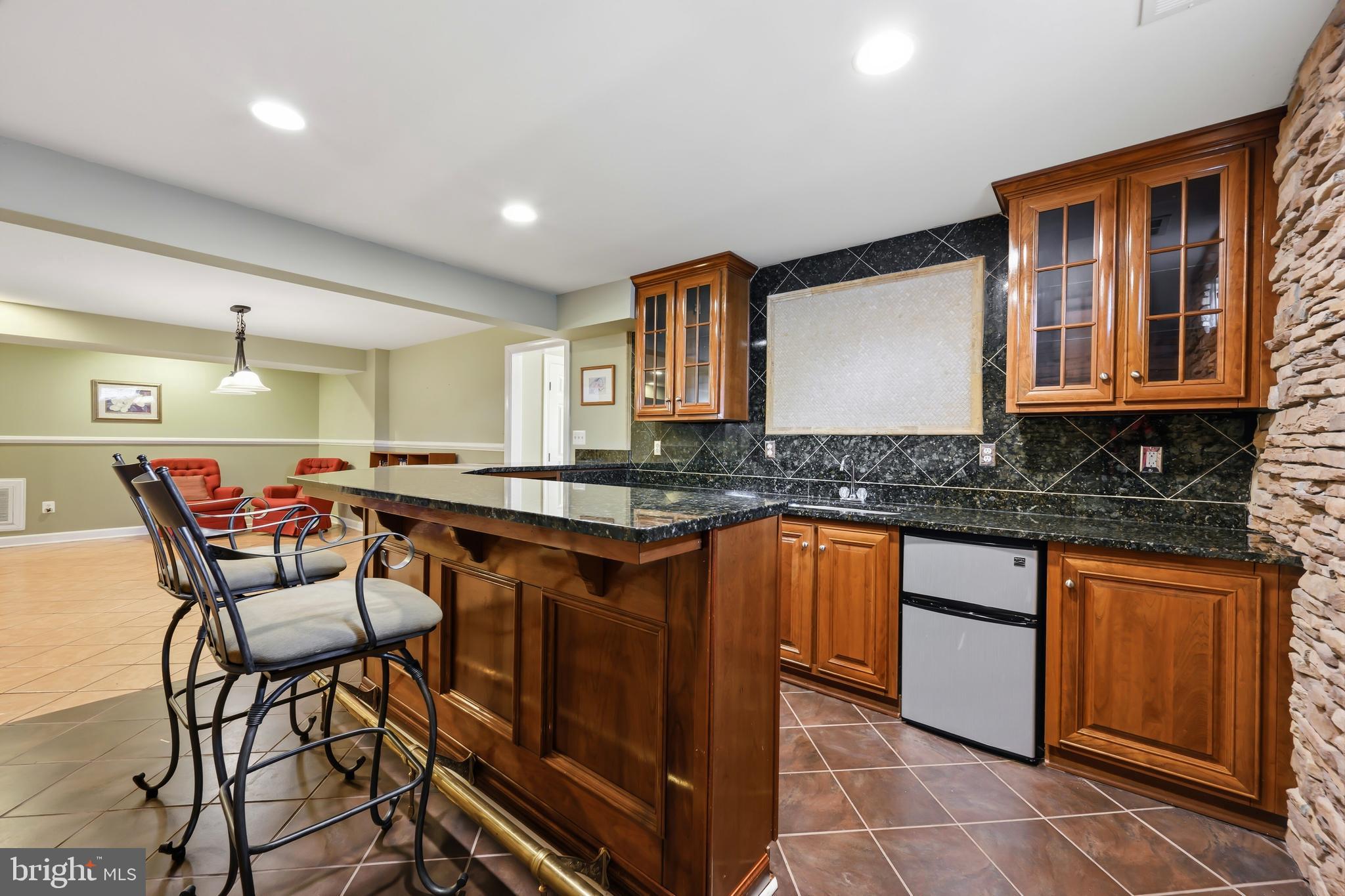 103 Sutton Way Chestertown, MD 21620 - Photo 52 of 53 a kitchen with stainless steel appliances granite countertop wooden cabinets a granite counter tops and a view of living room