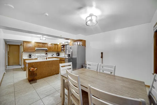 a large kitchen with a table and chairs