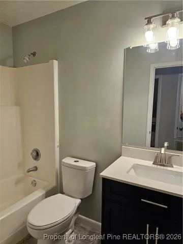 a bathroom with a sink toilet vanity and shower