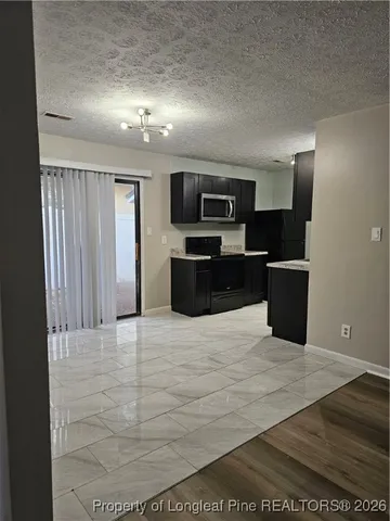 a large room with a bed and a television