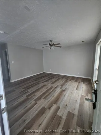 a view of a room with wooden floor