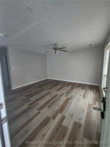 a view of a room with wooden floor