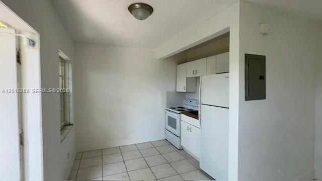 441 Southwest 10th Street, Unit 4 Miami, FL 33130 - Photo 3 of 18 a kitchen with white cabinets and white appliances