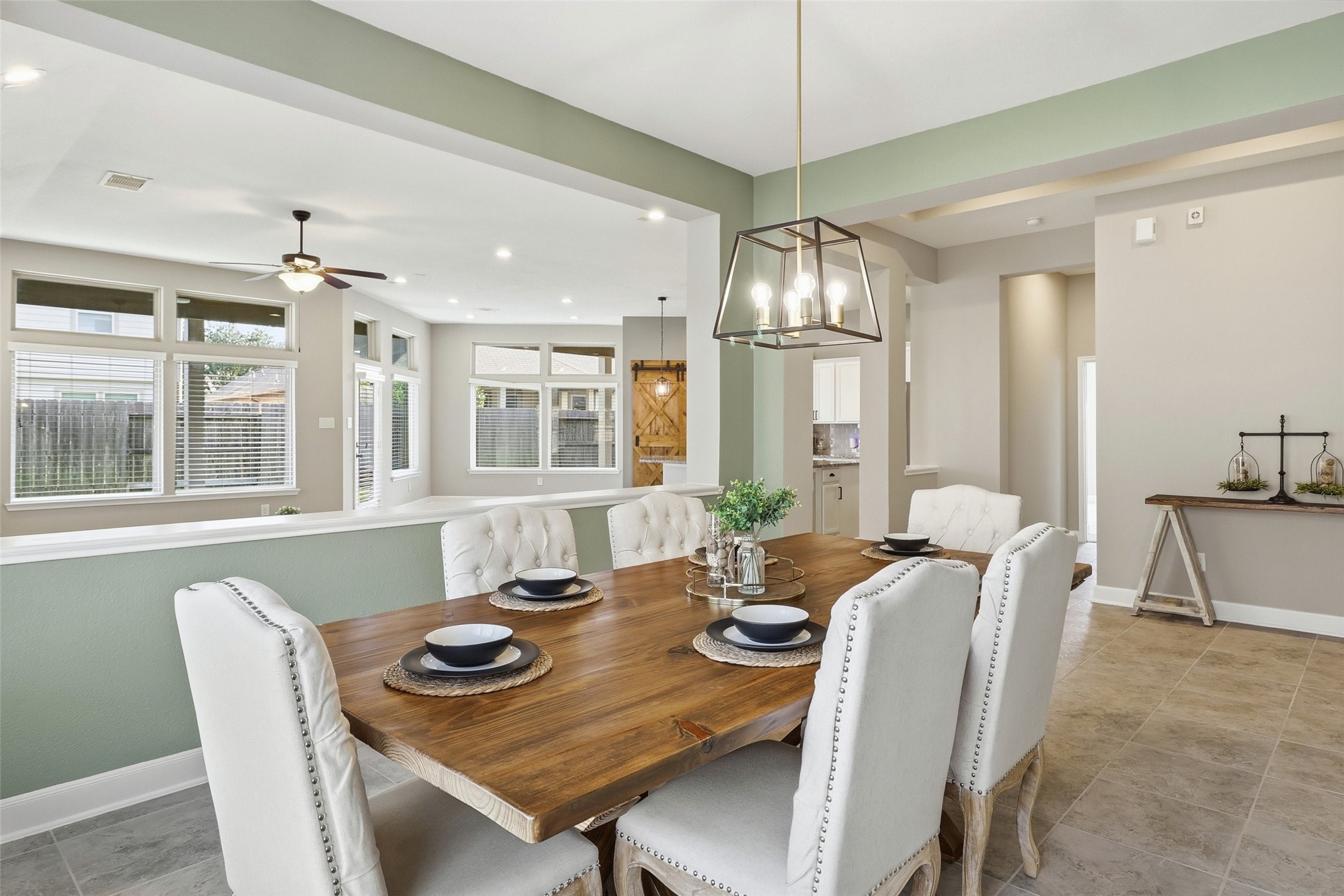 24126 Cane Fields Road Katy, TX 77493 - Photo 2 of 36 Designer lighting elevates this spacious dining room, offering a sophisticated setting for entertaining and everyday living.