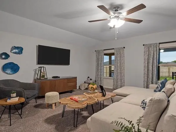 a living room with furniture and a flat screen tv