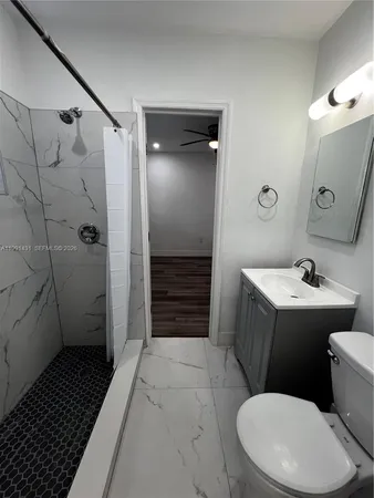 a bathroom with a sink toilet and shower