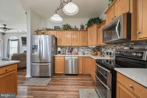 a kitchen with a refrigerator sink and cabinets