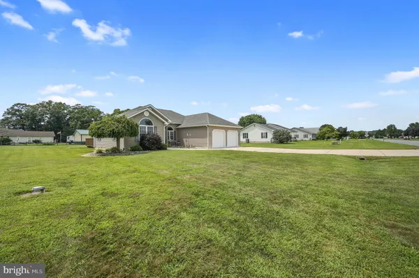 a view of a house with a yard and a garden