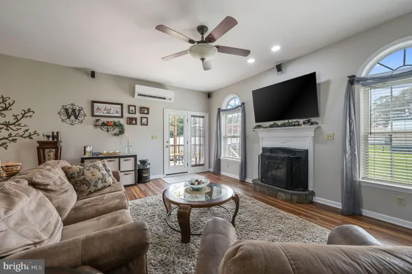 a living room with furniture a fireplace and a flat screen tv