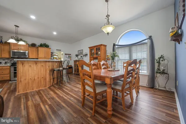 a view of a dining room with furniture and wooden floor