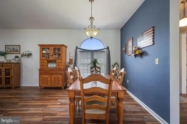 a view of a dining room with furniture wooden floor and chandelier