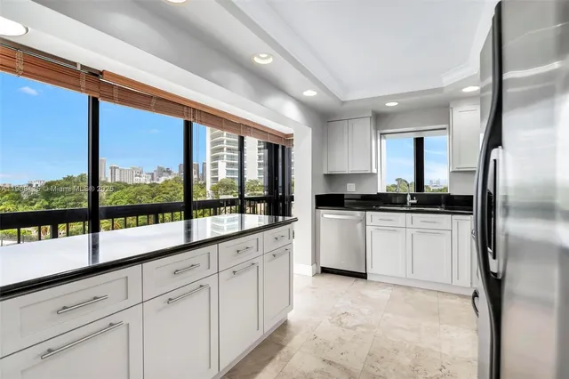 a spacious bathroom with a granite countertop sink mirror and a bathtub