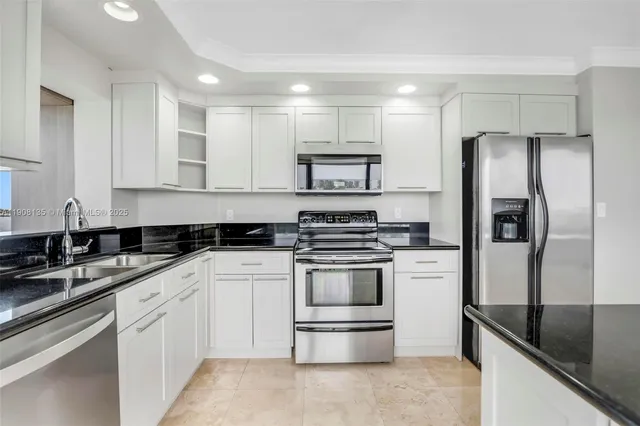 a spacious bathroom with a granite countertop sink a toilet and a large mirror