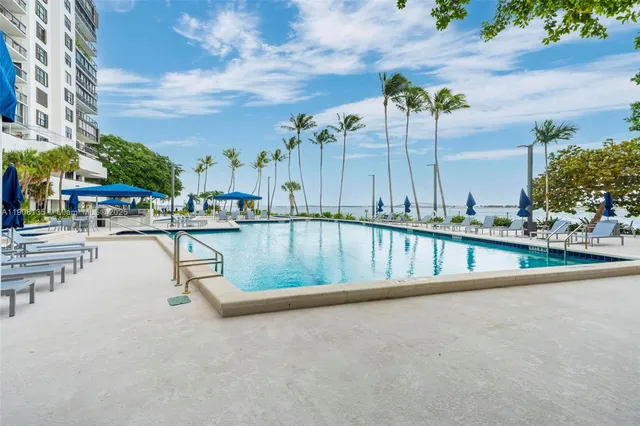 a view of a balcony with chairs and potted plants