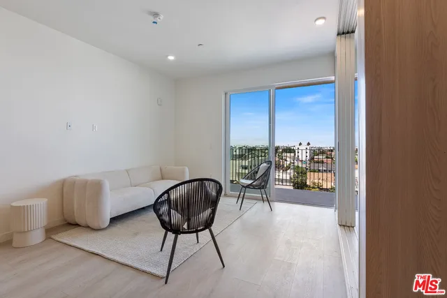 a view of a livingroom with furniture and a window