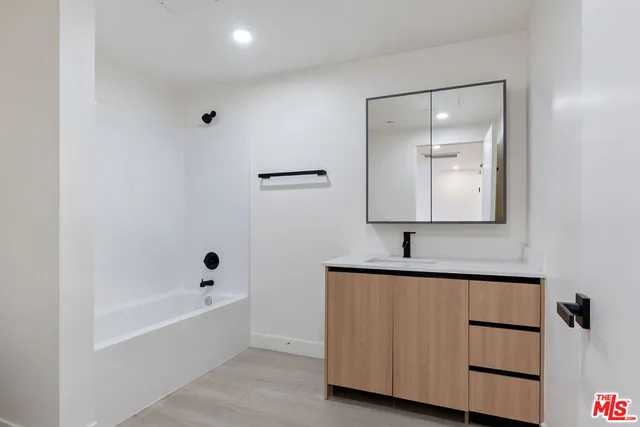 a bathroom with a bathtub and a sink