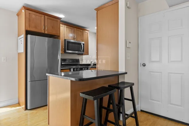 a kitchen with stainless steel appliances a refrigerator stove microwave and sink