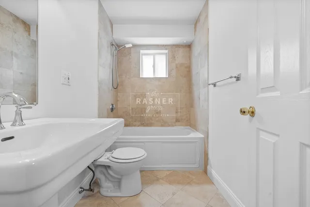 a bathroom with a toilet a sink and bathtub