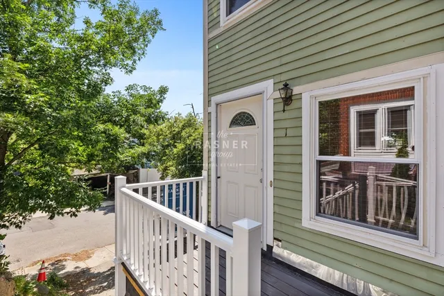 a view of porch with small deck and wooden fence