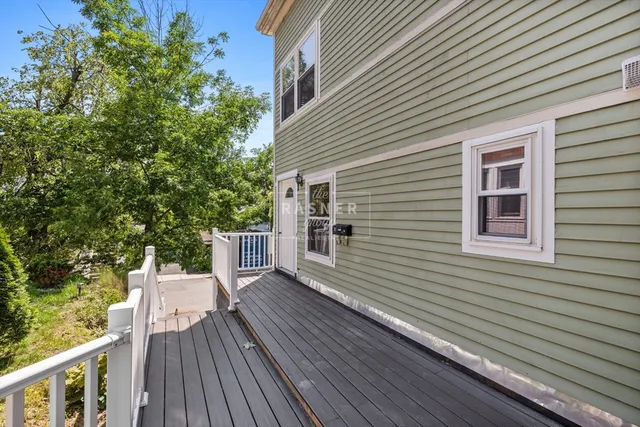 a view of a wooden deck next to a yard