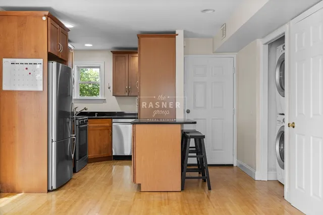 a kitchen with stainless steel appliances granite countertop a refrigerator and a stove