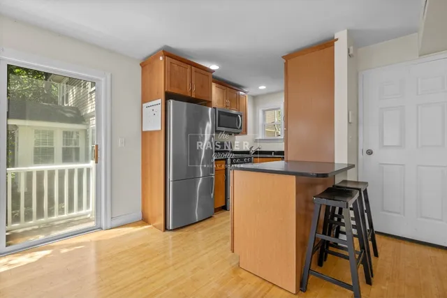 a kitchen with stainless steel appliances a refrigerator and a stove top oven