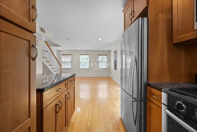 a view of a hallway with wooden floor and staircase