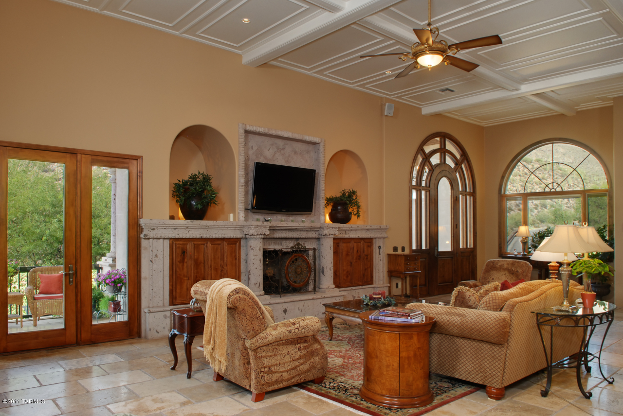 2188 East Buck Ridge Place Oro Valley, AZ 85737 - Photo 8 of 22 a living room with fireplace furniture and a large window