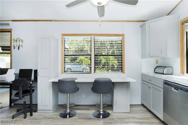 a view of a workspace with furniture and a window